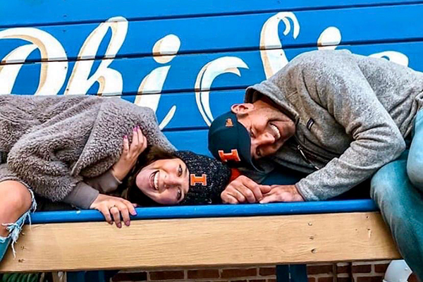 Greek father with daughter posing on bench.